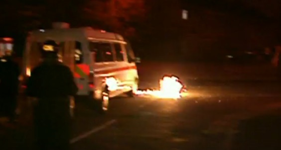 A screenshot from a video showing a fire accelerant being thrown near police during the riots (Picture: BBC)